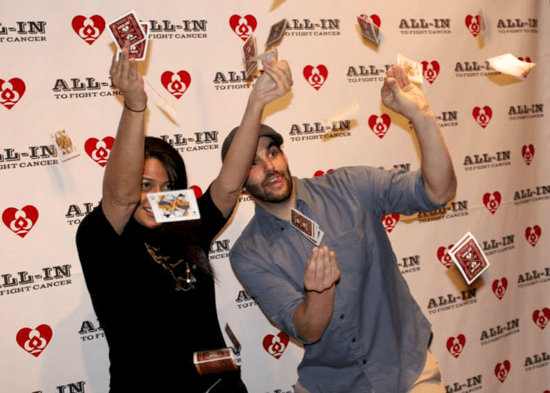 Two people at an All-In event throwing playing cards