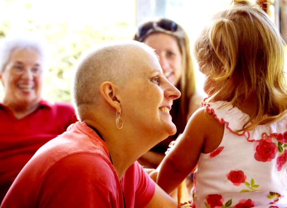 Woman smiling at a little girl